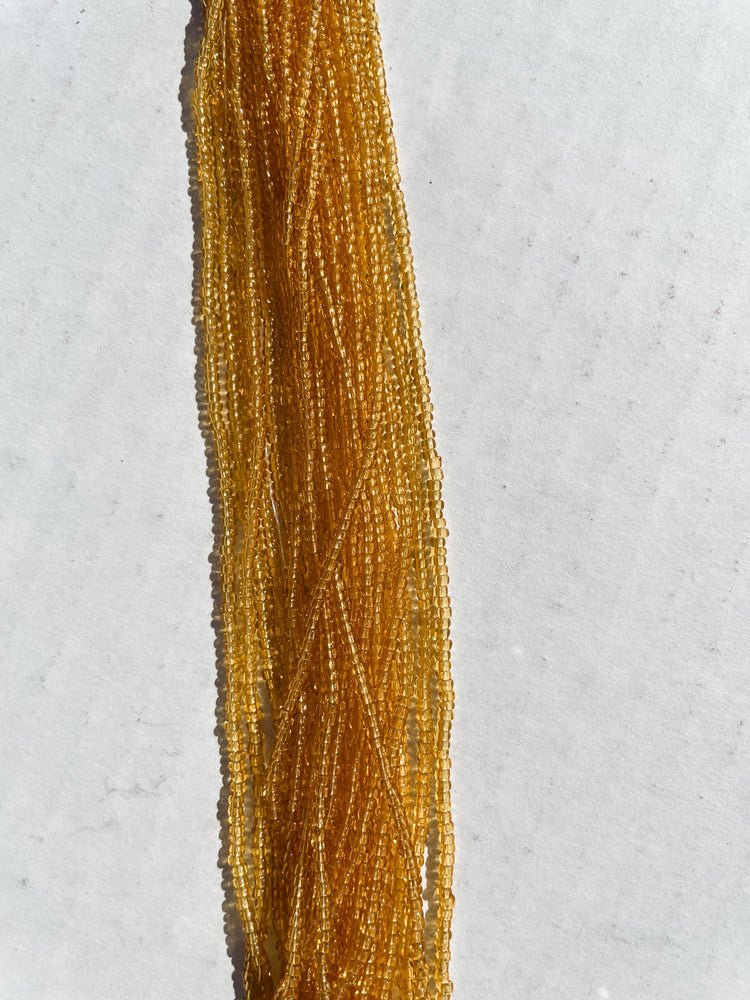 11/0 TRANSP. AMBER SEED BEADS